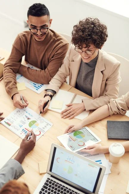 Two colleagues work together on a marketing strategy at a whiteboard, with attention on user-generated content.